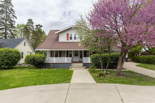view of front facade with a front yard and a porch