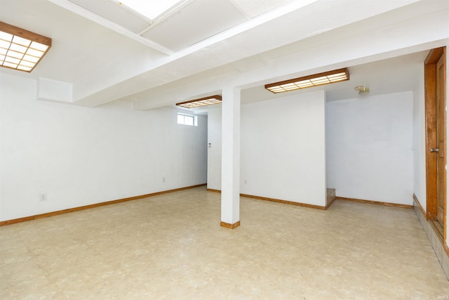 basement with light floors and baseboards