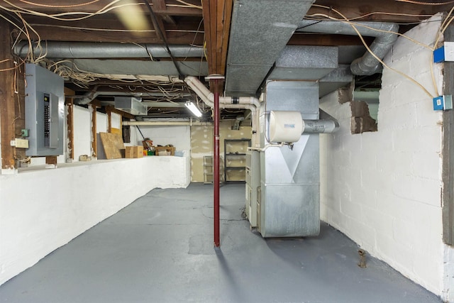 unfinished basement featuring electric panel and heating unit
