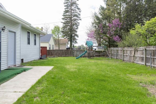 view of yard featuring a playground and a fenced backyard