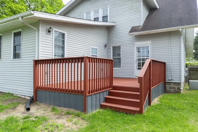 back of property featuring central AC unit, a wooden deck, and a shingled roof