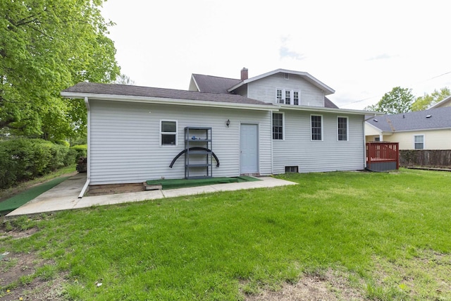 rear view of property with a lawn and a chimney