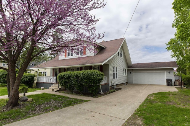 view of front of house featuring concrete driveway, a porch, an attached garage, and central AC unit