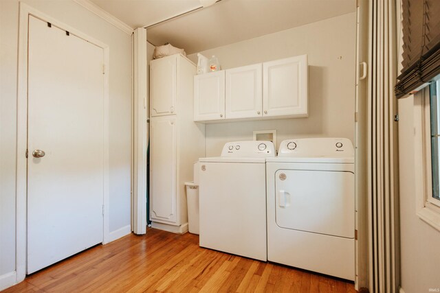 1732 Marbo Ave, Evansville, IN 47714 - clothes washing area featuring washing machine and dryer, cabinet space, and light wood-style floors