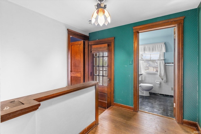 405 W Rudisill Blvd, Fort Wayne, IN 46807 - hallway with tile walls, baseboards, and hardwood / wood-style floors