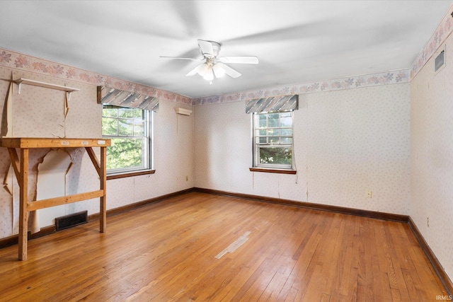 405 W Rudisill Blvd, Fort Wayne, IN 46807 - empty room with wallpapered walls, light wood-type flooring, visible vents, and a ceiling fan