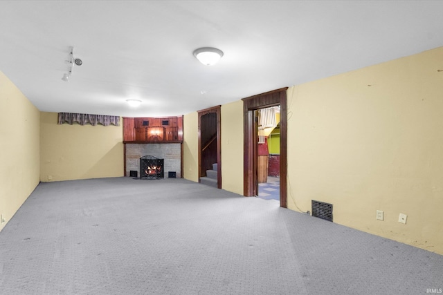 405 W Rudisill Blvd, Fort Wayne, IN 46807 - unfurnished living room with stairs, light carpet, a brick fireplace, and visible vents