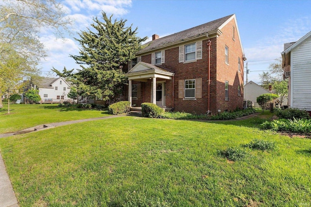 405 W Rudisill Blvd, Fort Wayne, IN 46807 - view of front of house with brick siding, a chimney, and a front yard