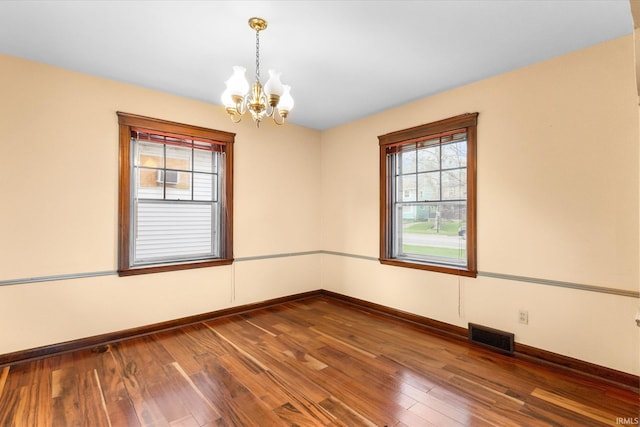 405 W Rudisill Blvd, Fort Wayne, IN 46807 - empty room featuring baseboards, a notable chandelier, visible vents, and dark wood-type flooring