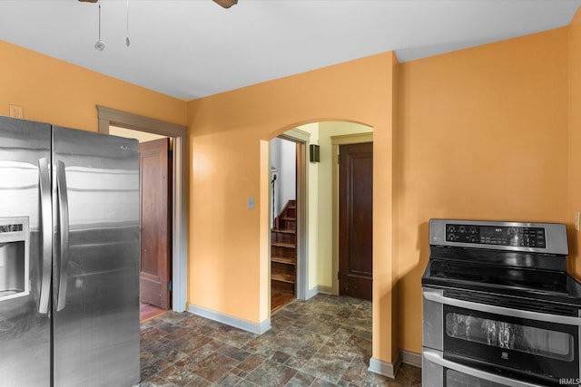405 W Rudisill Blvd, Fort Wayne, IN 46807 - kitchen with stainless steel appliances, arched walkways, stone finish floor, and baseboards