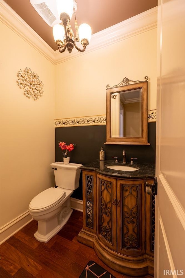 5318 Claiborn Ct, Newburgh, IN 47630 - half bathroom with toilet, wood finished floors, a chandelier, vanity, and ornamental molding