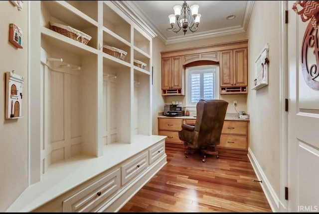 5318 Claiborn Ct, Newburgh, IN 47630 - home office featuring built in study area, a chandelier, ornamental molding, and light wood-style floors