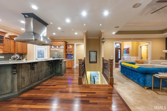 5318 Claiborn Ct, Newburgh, IN 47630 - kitchen with glass insert cabinets, stainless steel built in refrigerator, island exhaust hood, dark wood-type flooring, and arched walkways