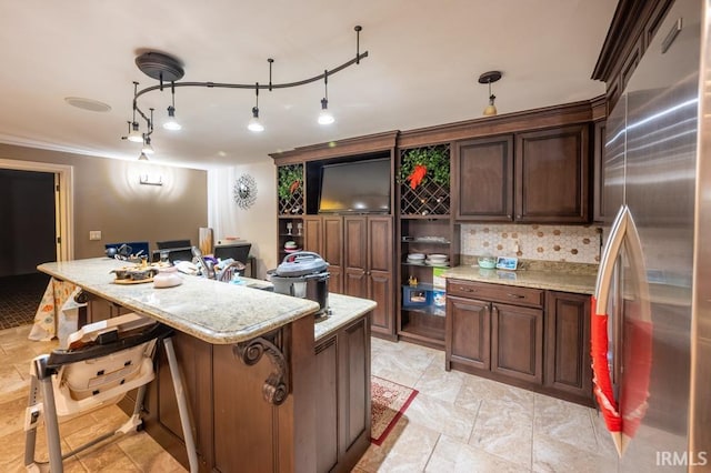 5318 Claiborn Ct, Newburgh, IN 47630 - kitchen featuring stainless steel fridge, a kitchen bar, pendant lighting, light stone countertops, and tasteful backsplash