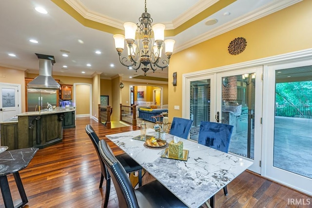5318 Claiborn Ct, Newburgh, IN 47630 - dining space with an inviting chandelier, a tray ceiling, crown molding, and dark wood-type flooring