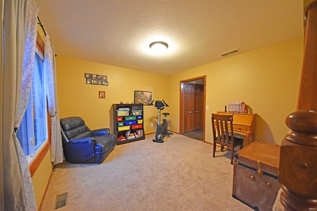 rec room with carpet flooring, visible vents, and a textured ceiling