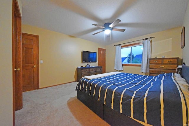 bedroom with a ceiling fan, baseboards, and carpet