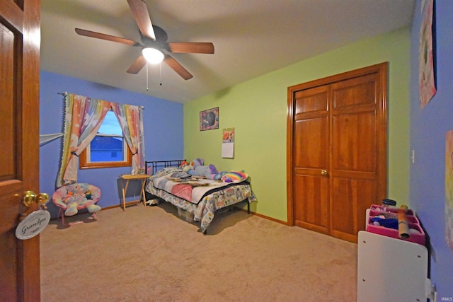 carpeted bedroom with baseboards and a ceiling fan