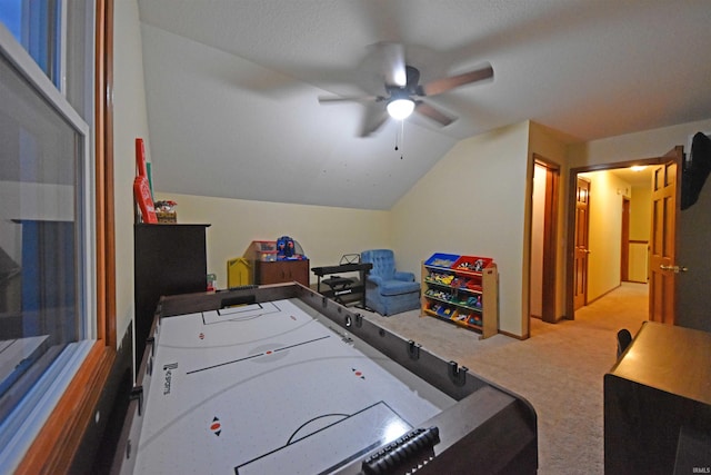 recreation room with ceiling fan, lofted ceiling, and carpet flooring