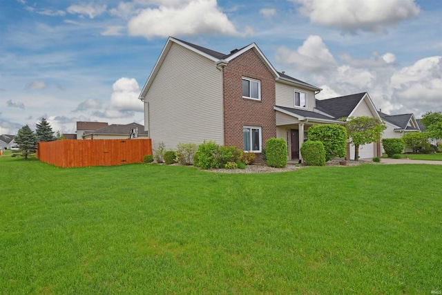 view of home's exterior with a lawn, driveway, brick siding, fence, and a garage