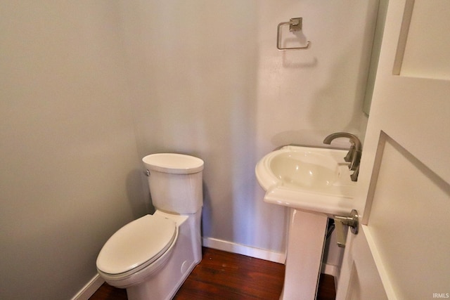 1776 N Royal Oaks Dr, Monticello, IN 47960 - bathroom with baseboards, wood finished floors, and toilet