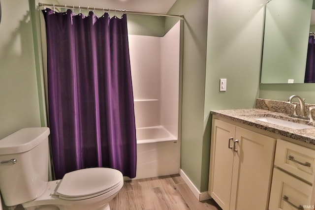 1776 N Royal Oaks Dr, Monticello, IN 47960 - full bath with wood finished floors, toilet, vanity, shower / bath combination with curtain, and baseboards
