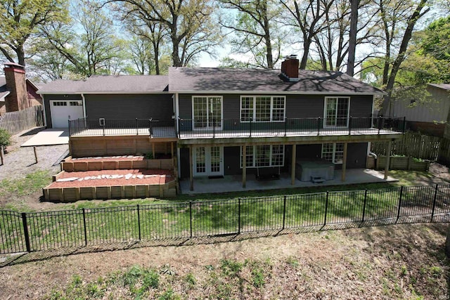 1776 N Royal Oaks Dr, Monticello, IN 47960 - rear view of house with french doors, a garage, a chimney, a patio, and a hot tub