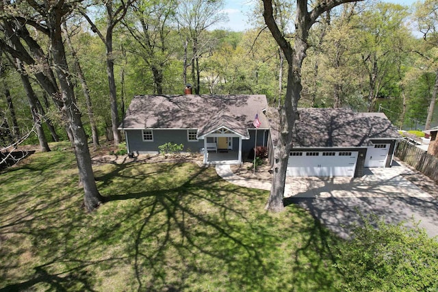 1776 N Royal Oaks Dr, Monticello, IN 47960 - ranch-style home with a chimney, driveway, roof with shingles, and a view of trees