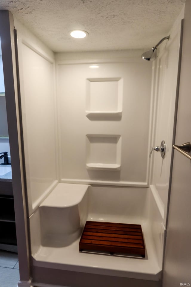 1660 W 8th St, Bloomington, IN 47404 - bathroom featuring a textured ceiling, a shower, tile patterned floors, and recessed lighting