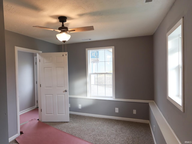 1660 W 8th St, Bloomington, IN 47404 - spare room featuring ceiling fan, carpet floors, and baseboards
