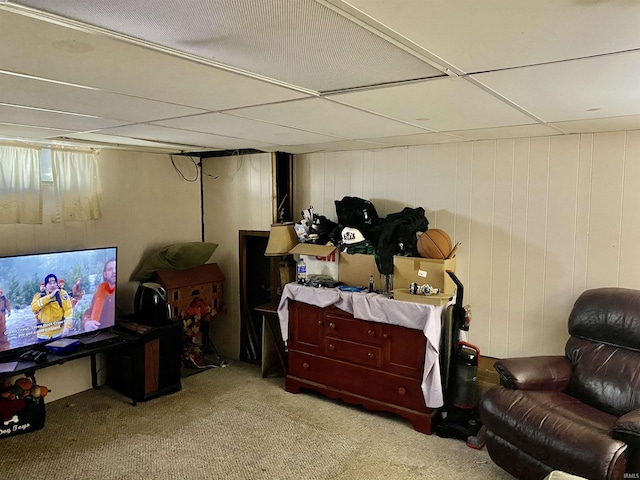 basement with carpet and a drop ceiling