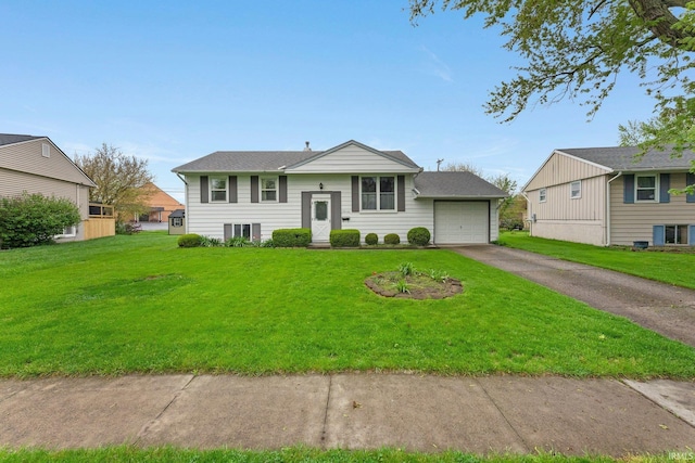 raised ranch featuring asphalt driveway, a front yard, and an attached garage