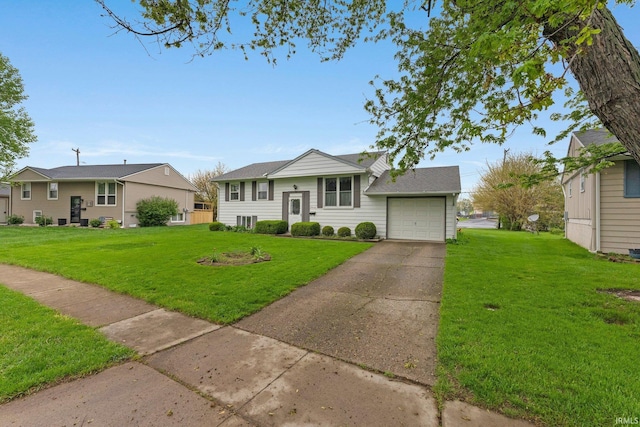 raised ranch featuring a front lawn, concrete driveway, and an attached garage
