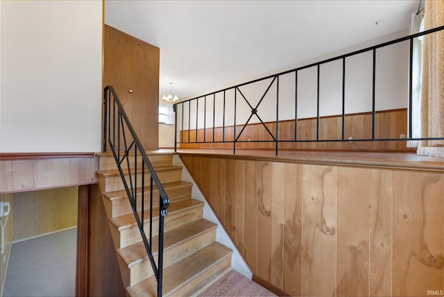stairs with a chandelier