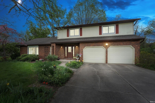 traditional-style house with a garage, concrete driveway, and brick siding