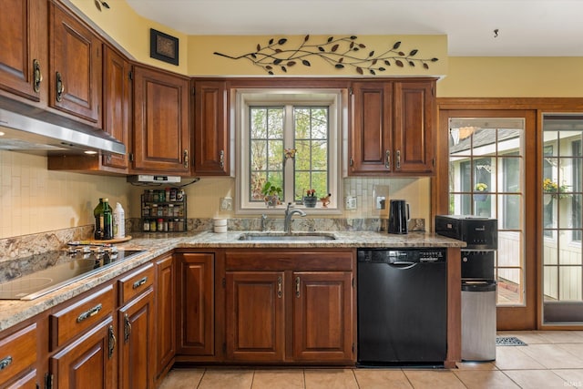 kitchen featuring black appliances, a sink, under cabinet range hood, tasteful backsplash, and light tile patterned flooring