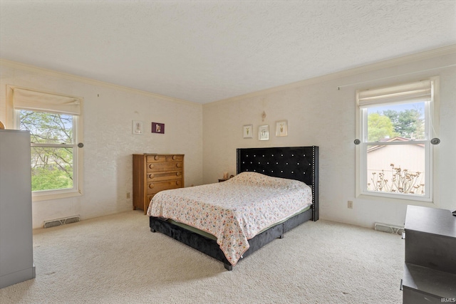 bedroom with ornamental molding and carpet flooring