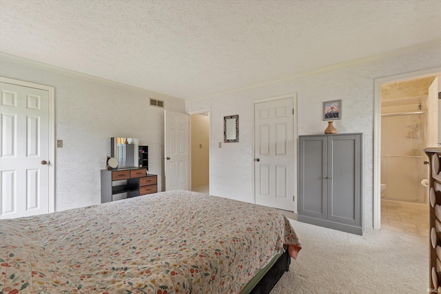carpeted bedroom featuring crown molding, a textured ceiling, and ensuite bath
