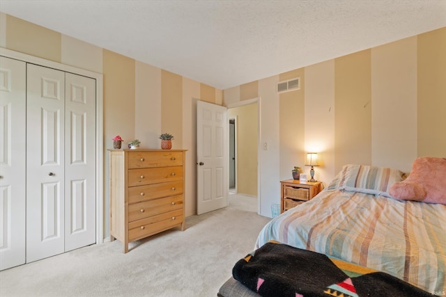bedroom with light colored carpet and a closet