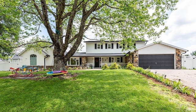 4346 N Centennial Dr, Bloomington, IN 47404 - traditional-style house featuring an attached garage, stone siding, driveway, and covered porch