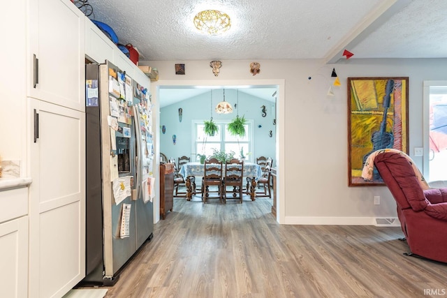 4346 N Centennial Dr, Bloomington, IN 47404 - hallway with light wood-style floors, plenty of natural light, a textured ceiling, and baseboards