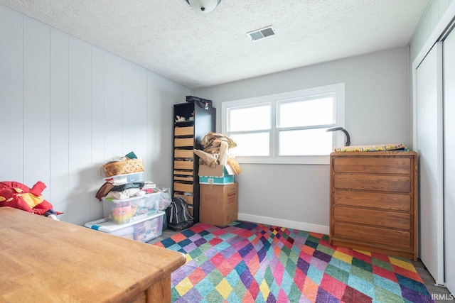 4346 N Centennial Dr, Bloomington, IN 47404 - bedroom featuring a textured ceiling, baseboards, and a closet