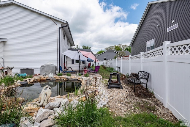 4346 N Centennial Dr, Bloomington, IN 47404 - fenced backyard with central AC and a patio area