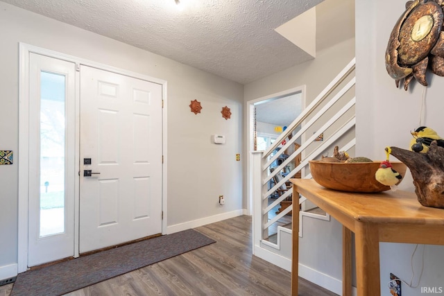 4346 N Centennial Dr, Bloomington, IN 47404 - foyer with stairs, wood finished floors, a textured ceiling, and baseboards