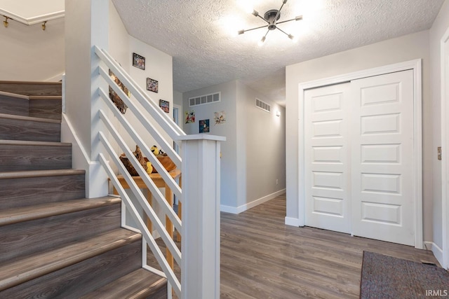 4346 N Centennial Dr, Bloomington, IN 47404 - stairs featuring a textured ceiling, wood finished floors, and baseboards