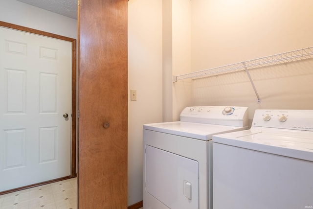 clothes washing area featuring washer and dryer and light floors