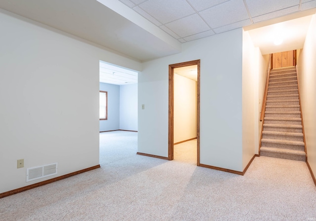 carpeted spare room with stairs and baseboards
