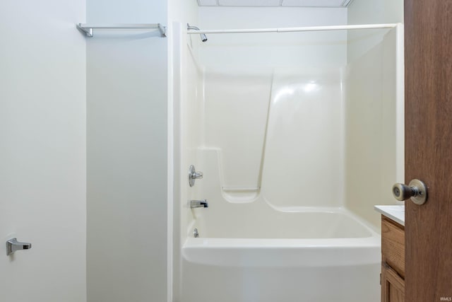 bathroom featuring vanity and  shower combination