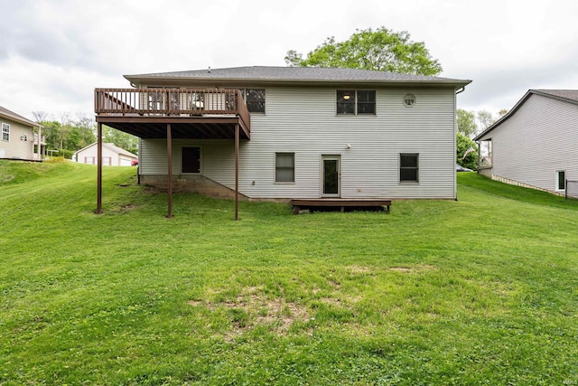 rear view of house with a wooden deck and a yard