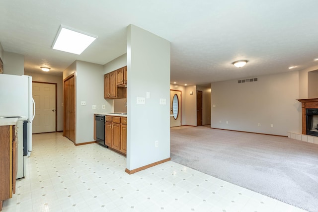 kitchen featuring brown cabinetry, open floor plan, dishwasher, baseboards, and light countertops